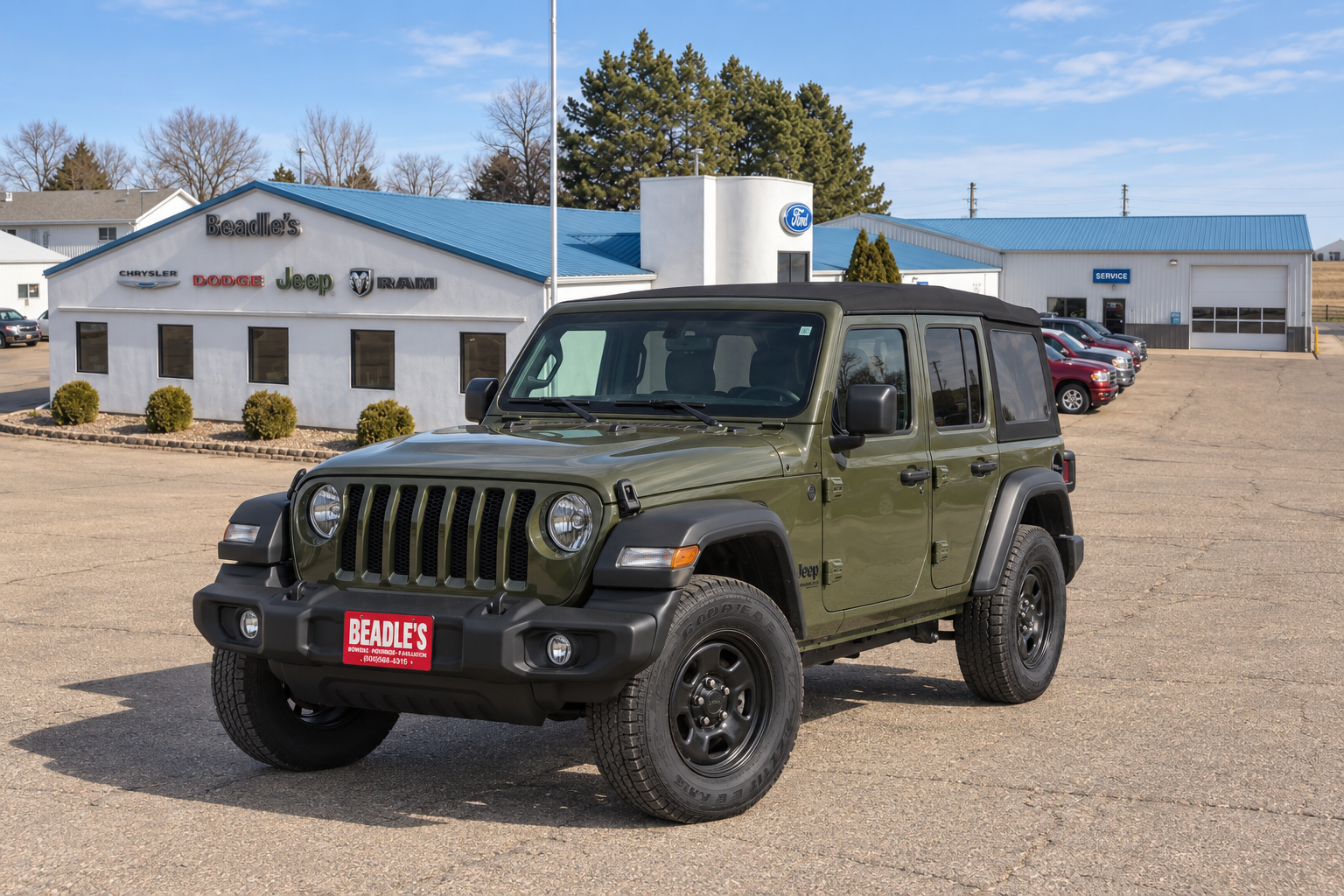 2026 Jeep Wrangler Sport parked in front of the Beadle's Chrysler Center building in Bowdle, South Dakota, at Beadle's Chrysler Center